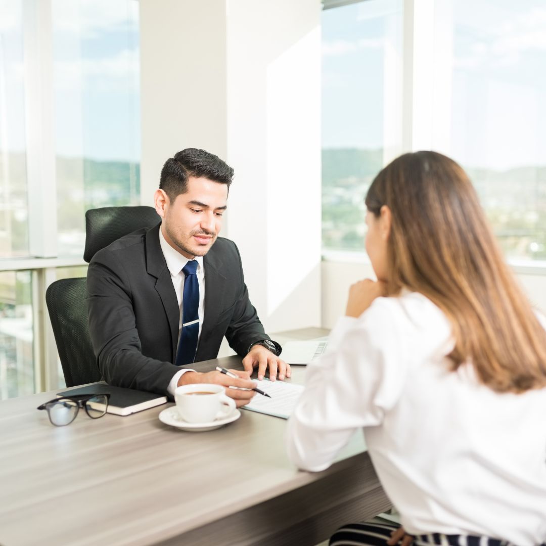 a man going over paperwork with a women in an office