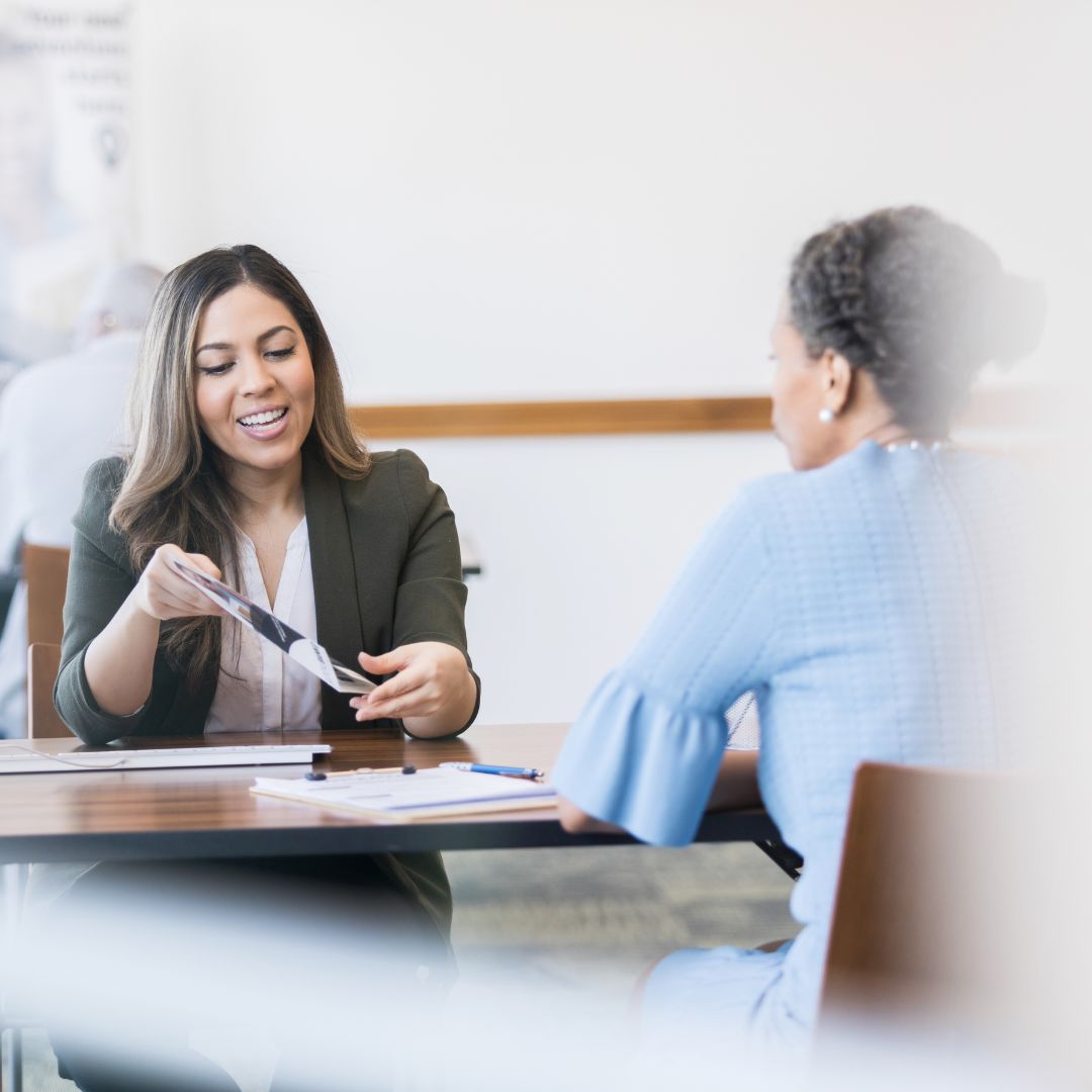 a women looking over loan paperwork with a client