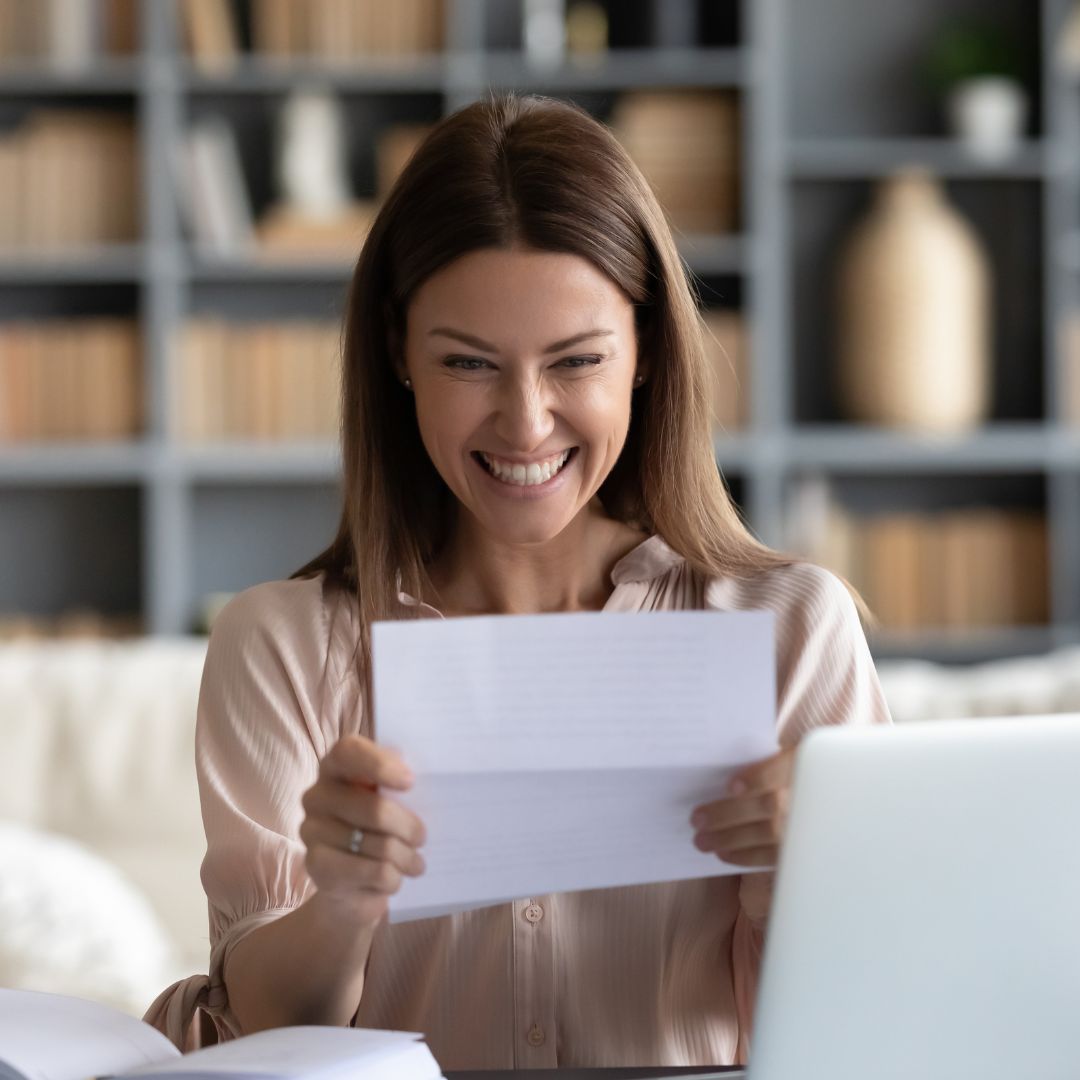 a women looking at paperwork being excited for her pre-approval